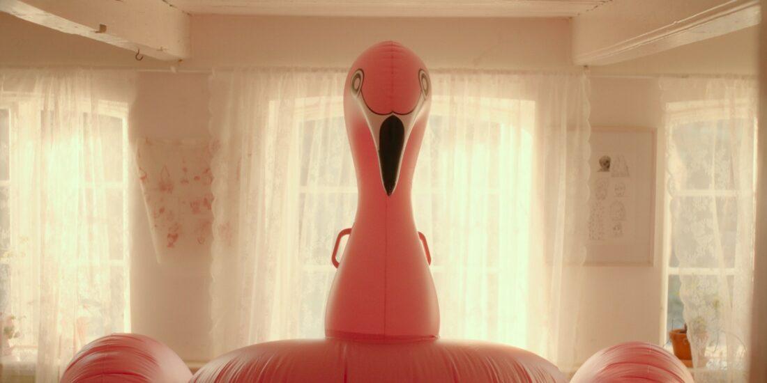 A flamingo floatie inside a house.