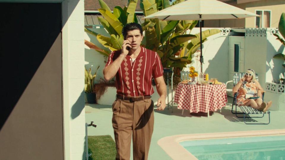 back in baby's arms - mystic film festival - narrative short - featured image - person talking on the phone by the pool